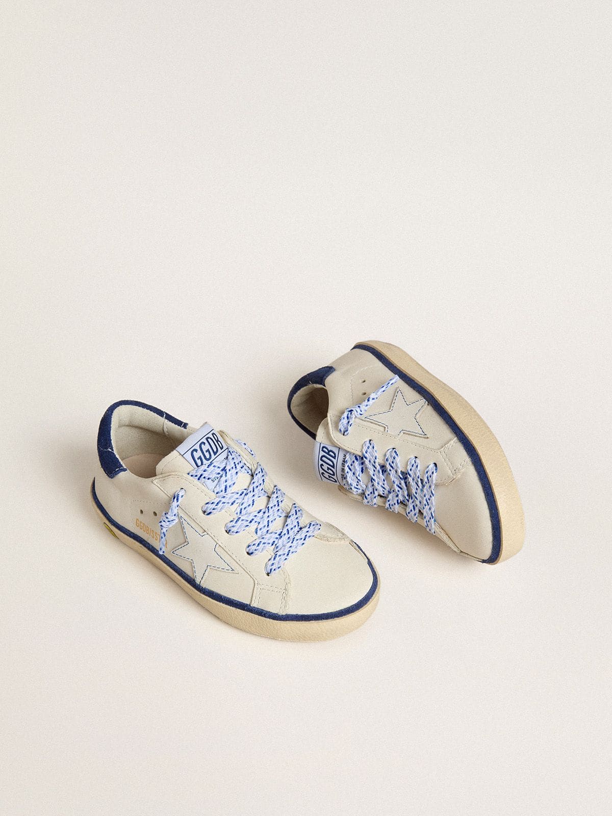 Junior Super-Star in white leather with blue suede heel tab