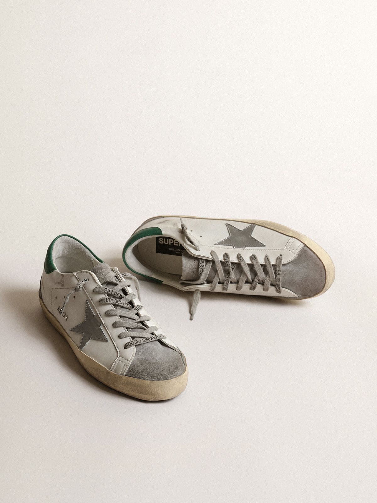 Men’s Super-Star in white leather with silver star and green heel tab