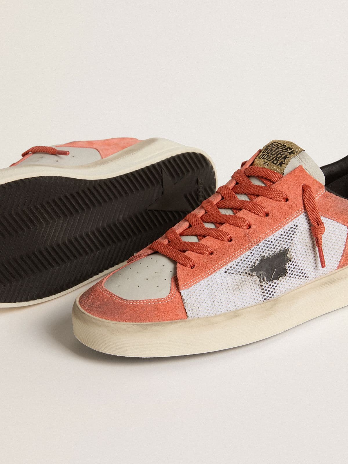 Stardan LTD in coral-colored suede and mesh with black leather star