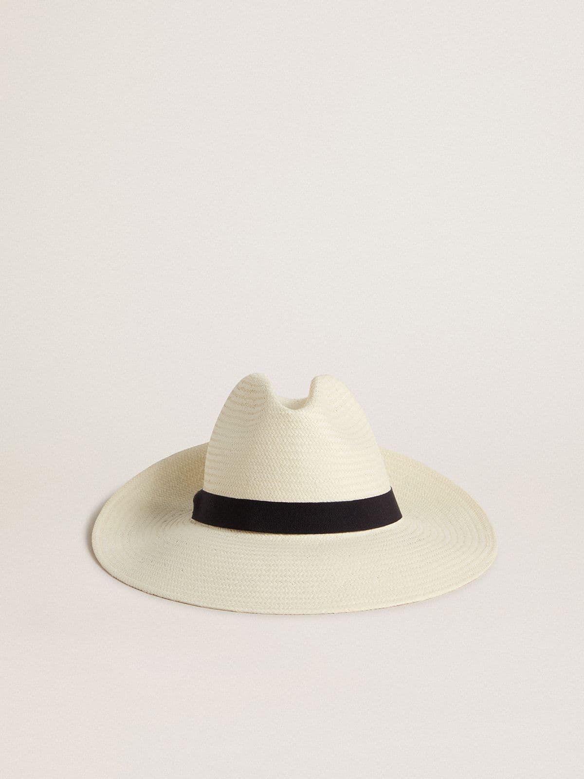 Golden fedora hat in white straw with black ribbon and marine print under the brim