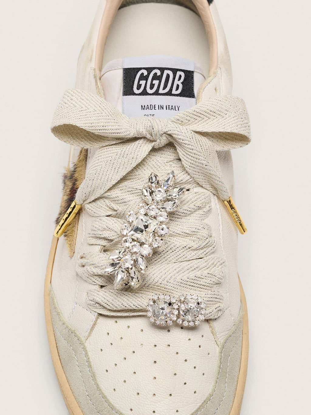 Skin "Sparkling" cream and silver herringbone laces with two appliqué charms