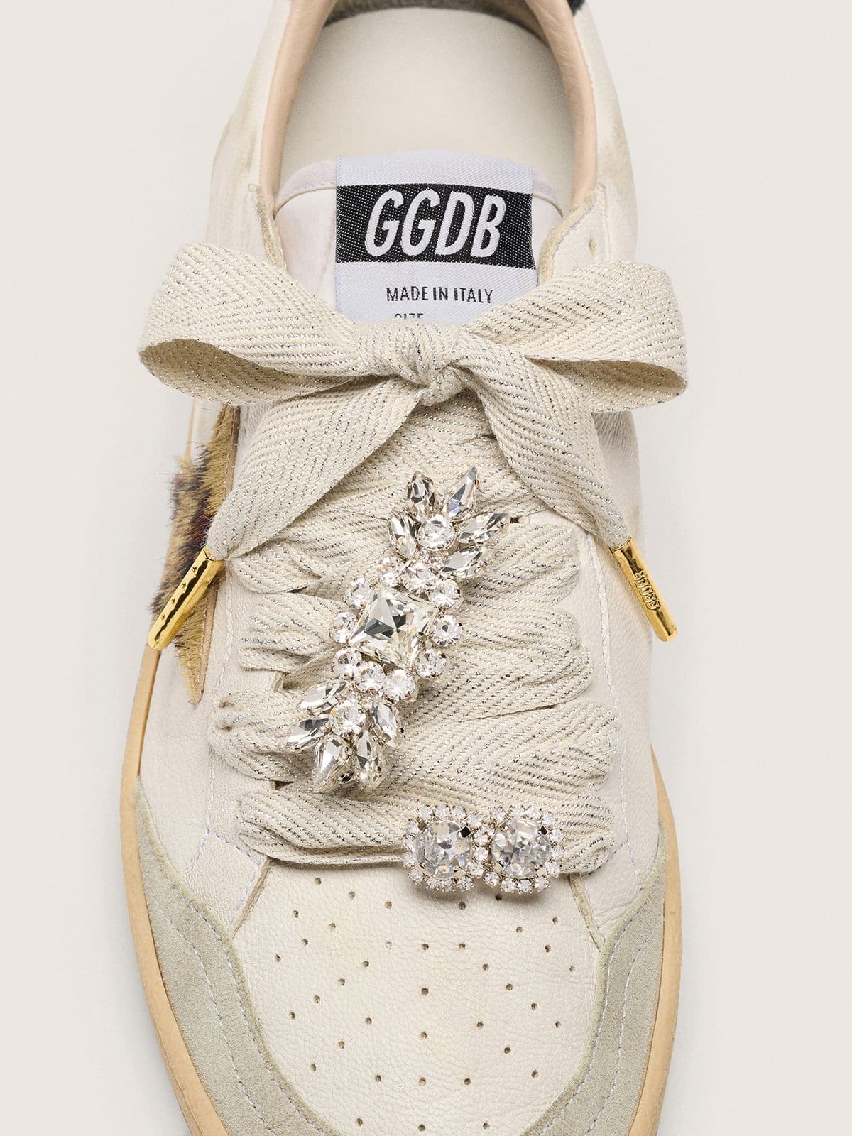Skin "Sparkling" cream and silver herringbone laces with two appliqué charms
