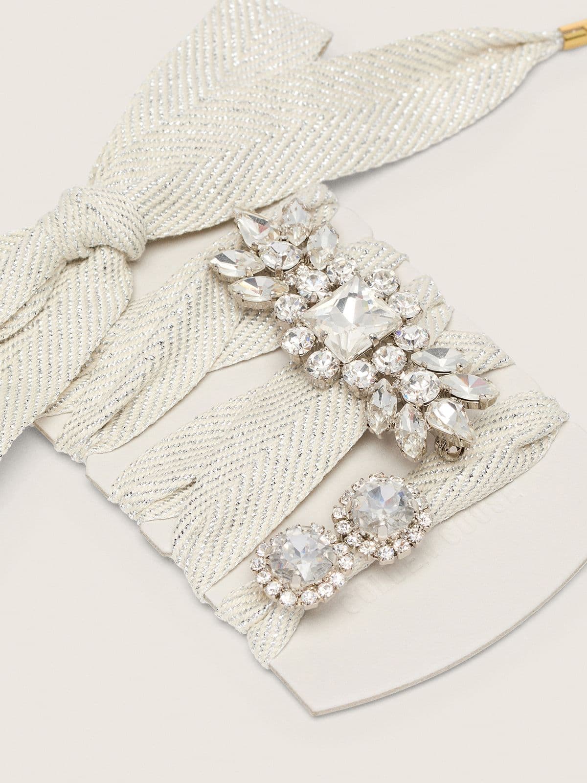 Skin "Sparkling" cream and silver herringbone laces with two appliqué charms