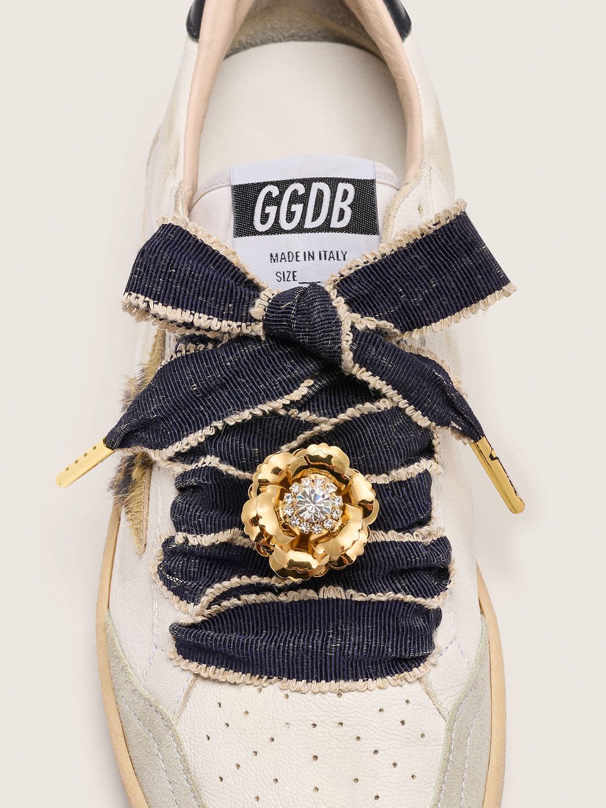 Skin "Sparkling" denim blue laces with beige trim and a golden charm