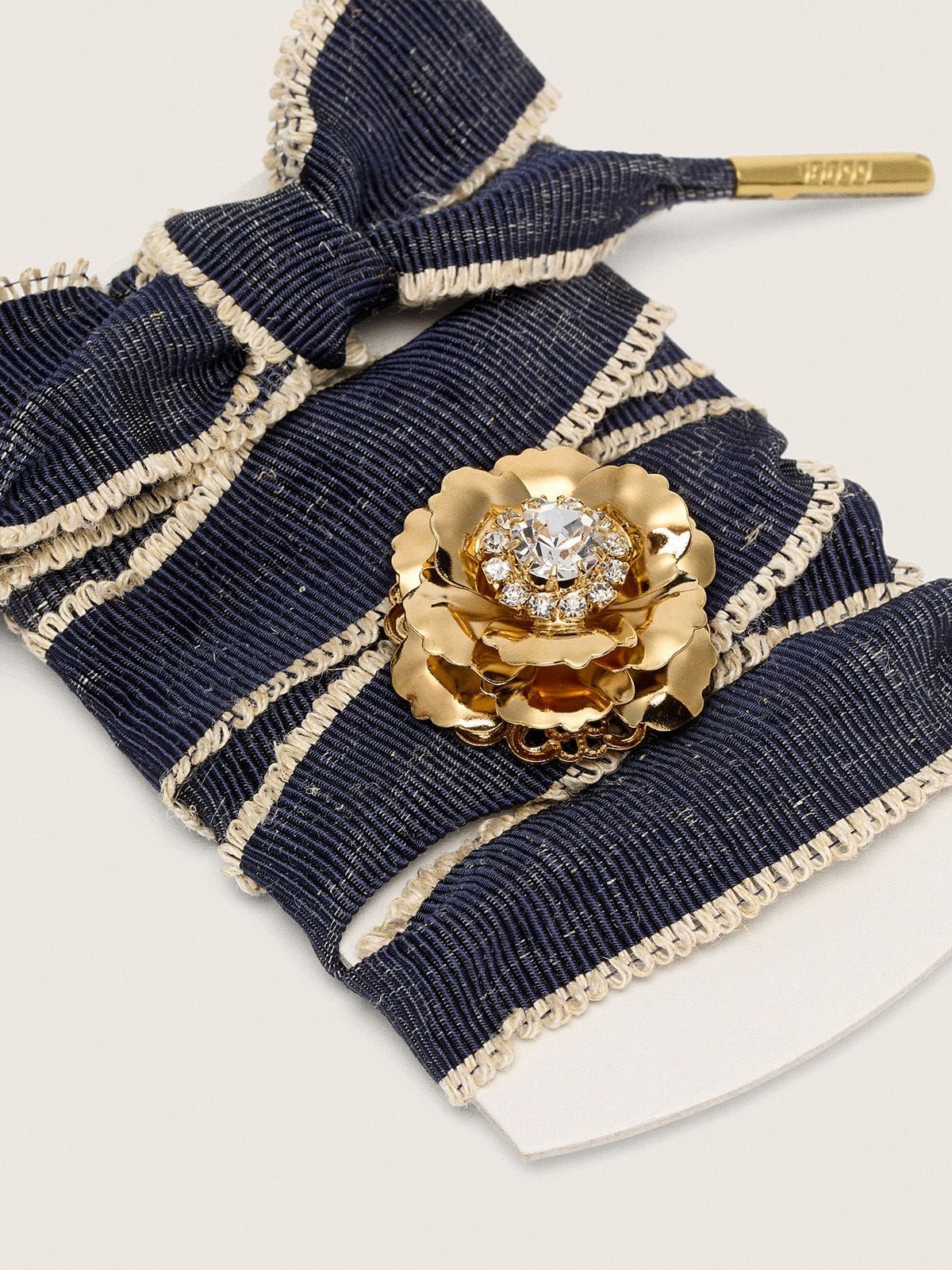 Skin "Sparkling" denim blue laces with beige trim and a golden charm