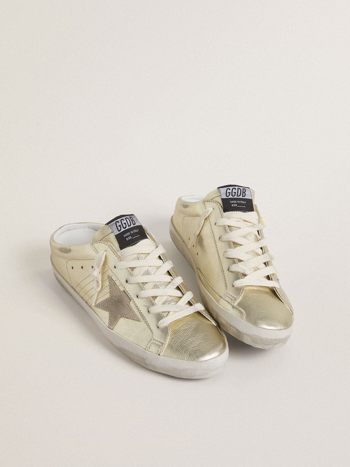 Super-Star Sabots in platinum foiled leather with beige suede star