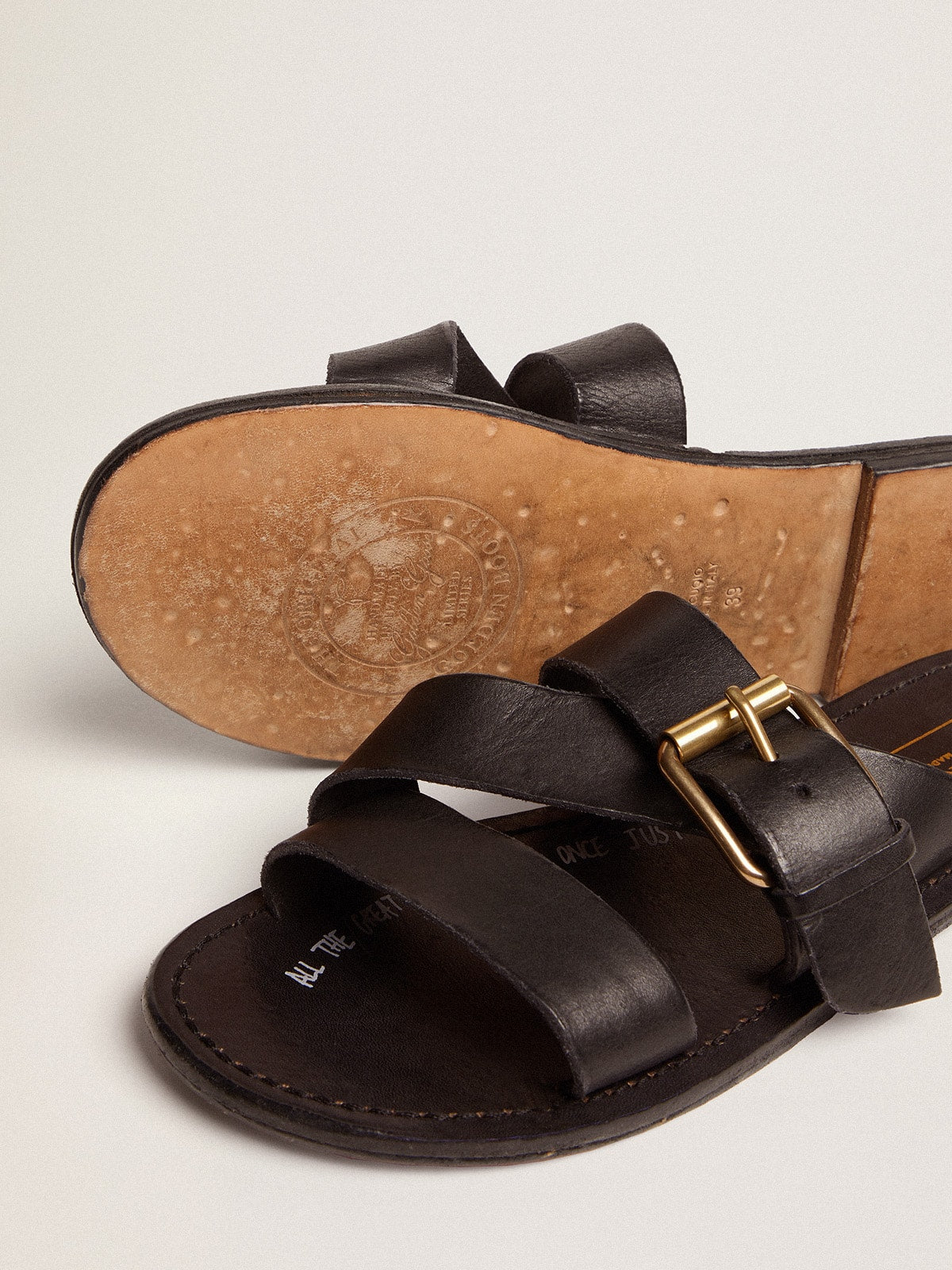 Women's Margaret flat sandals in black resin-coated leather