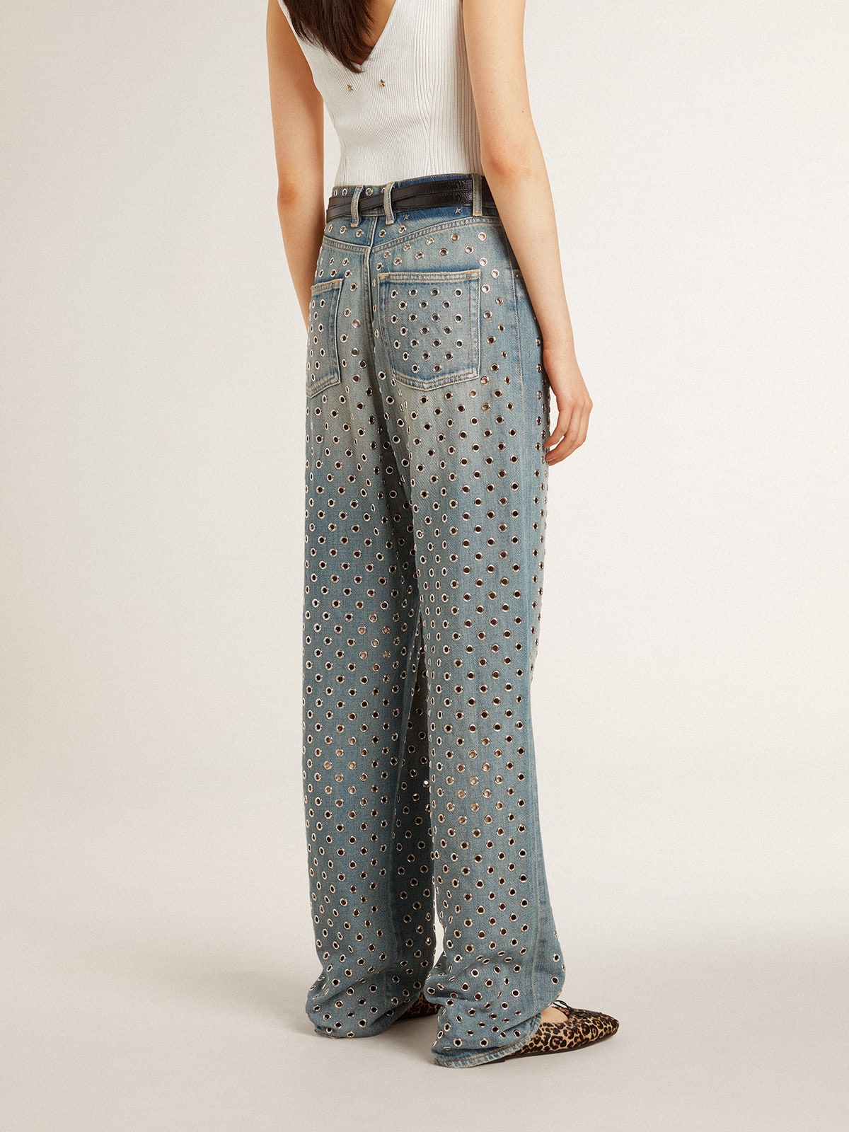 Women's washed jeans with all-over eyelets